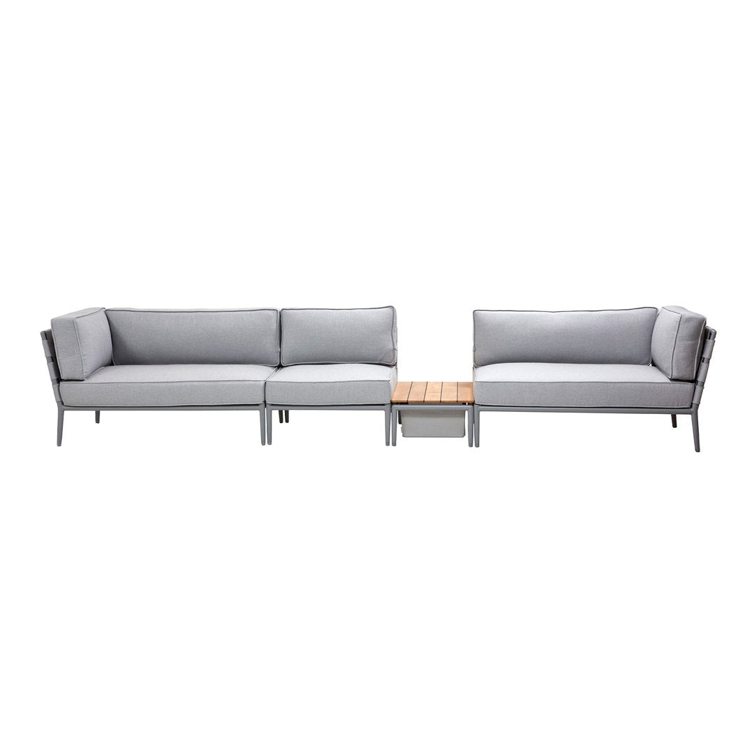Modern outdoor seating set featuring gray cushions and sleek metal frames with a wooden accent table.