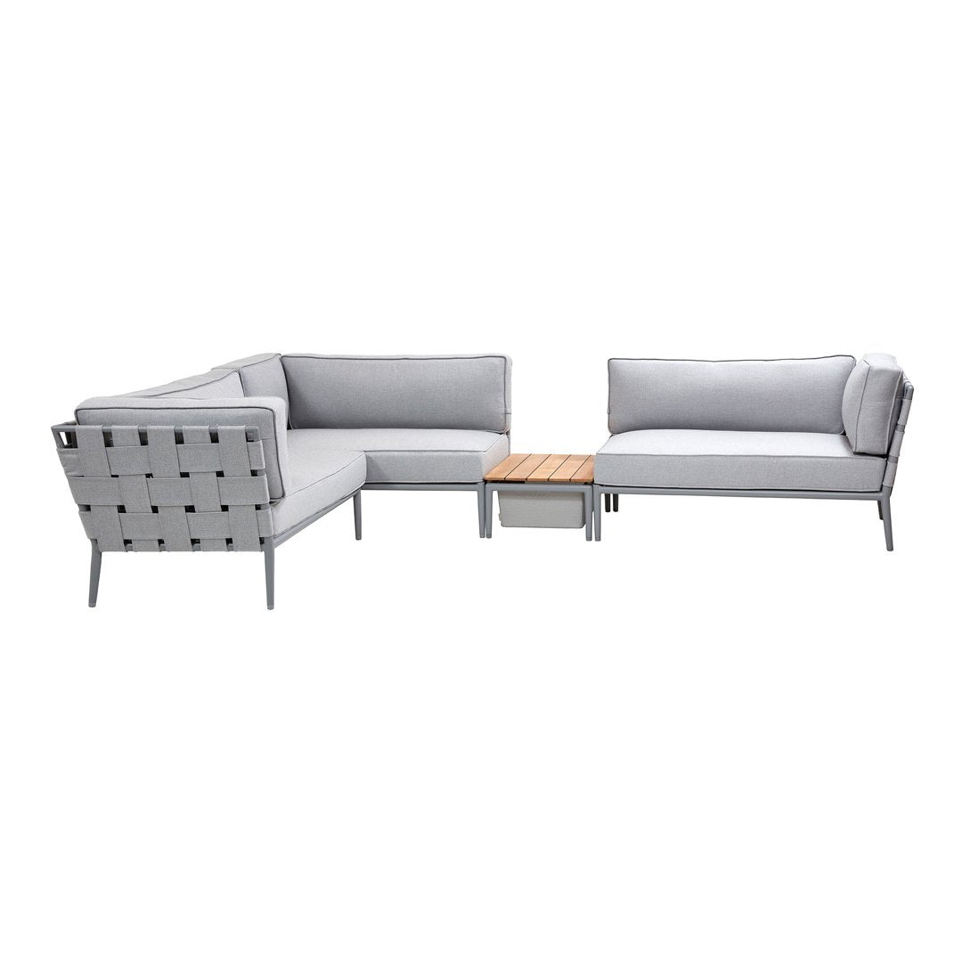 Stylish gray outdoor sectional sofa with a modern design and natural wood accent table. Perfect for any patio or garden.