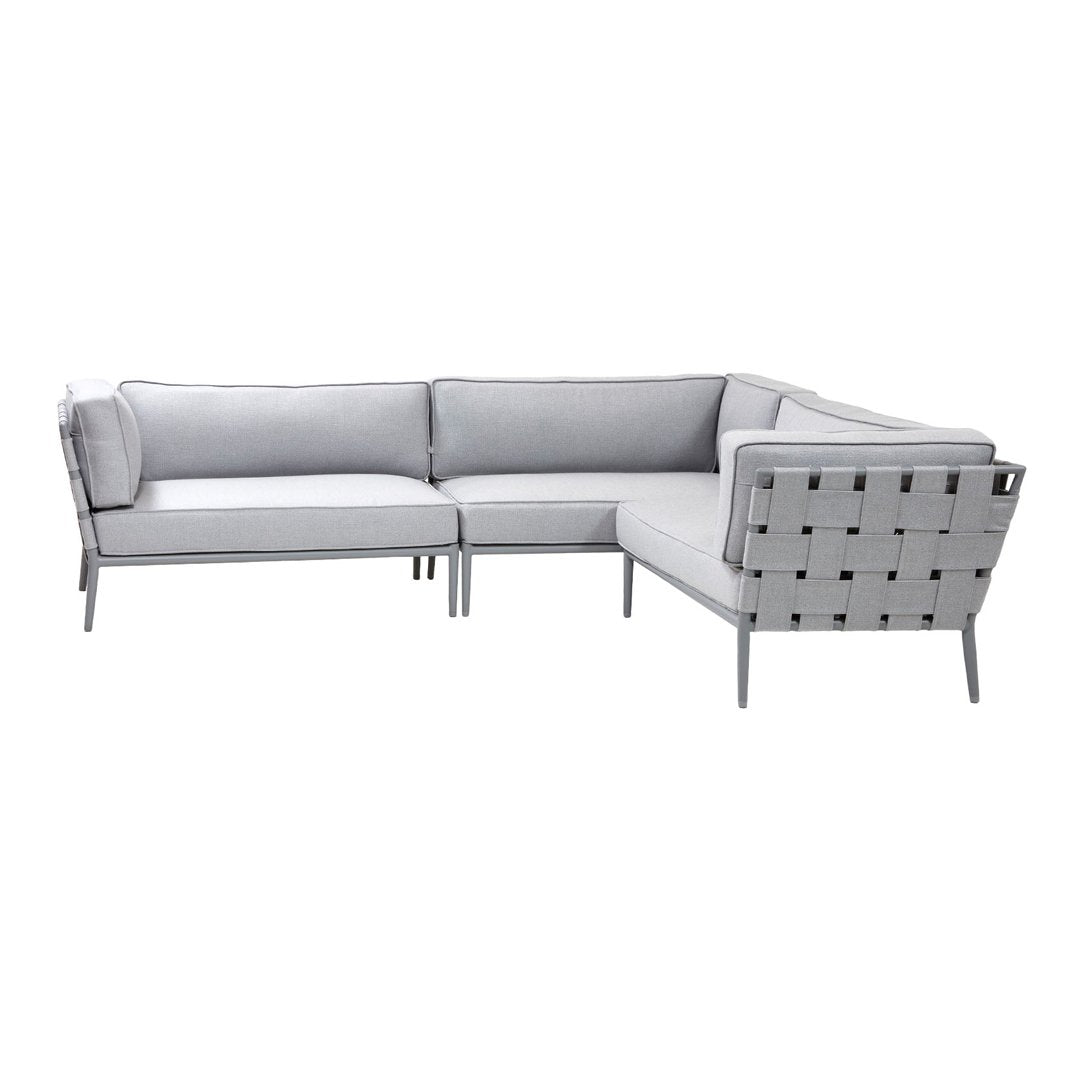 Gray sectional sofa with a geometric pattern and sleek metal accents. Modern design for stylish living spaces.