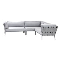 Gray sectional sofa with a geometric pattern and sleek metal accents. Modern design for stylish living spaces.