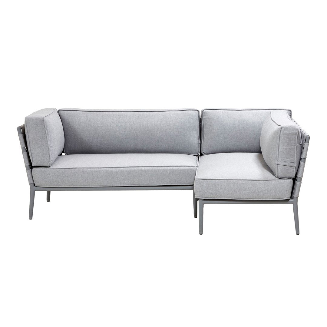 Gray sectional sofa with clean lines and subtle pattern, featuring plush cushions and sleek metal legs.