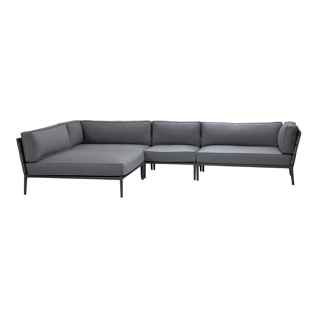 Gray sectional sofa with sleek contrasting black frame, featuring a modern, minimalist design. Perfect for contemporary decor.
