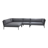 Gray sectional sofa with sleek contrasting black frame, featuring a modern, minimalist design. Perfect for contemporary decor.
