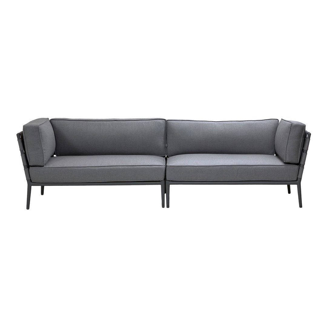 Gray upholstered sofa with sleek black metal frame, featuring a modern and minimalist design.