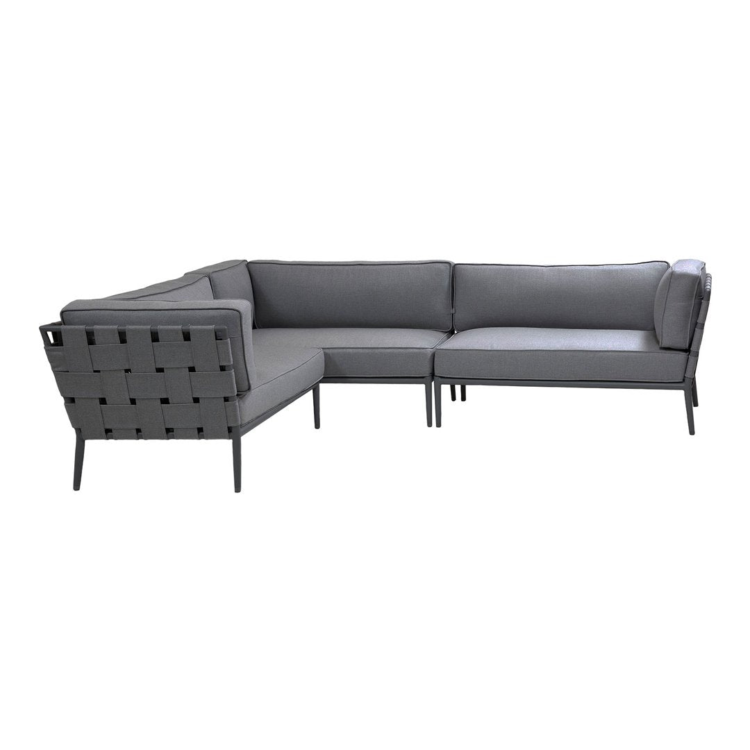 Gray sectional sofa with a sleek design and textured fabric, featuring clean lines and minimalistic patterns.