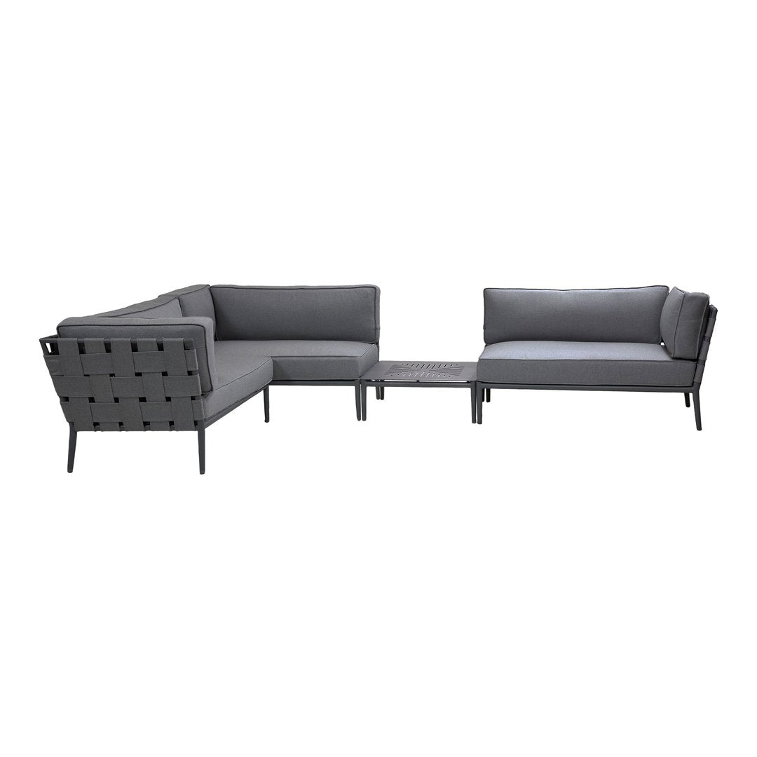 Gray sectional sofa with solid cushions and a modern design featuring sleek lines and minimalist patterns.