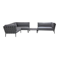 Gray sectional sofa with solid cushions and a modern design featuring sleek lines and minimalist patterns.