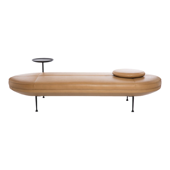 Tan leather chaise lounge with sleek black metal accents and soft circular cushion. Modern and minimalist design.
