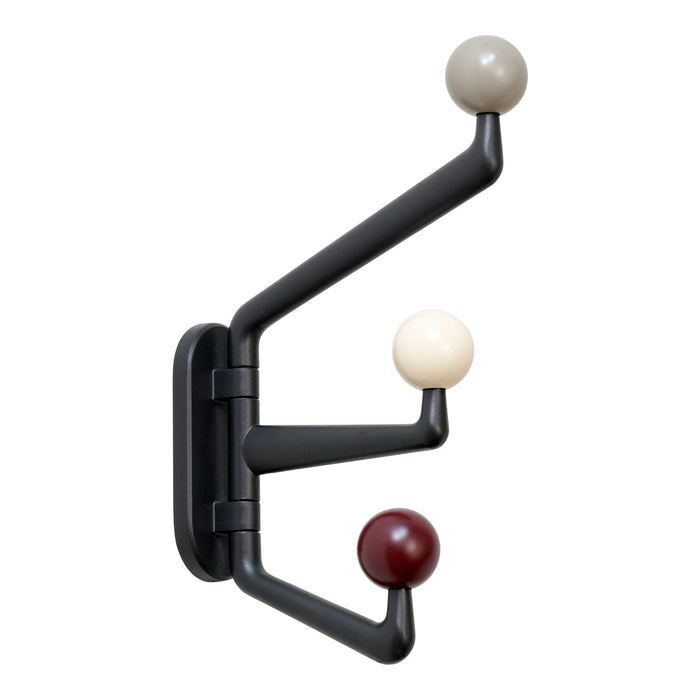 Black coat rack with three spherical knobs in beige, cream, and burgundy, featuring a modern geometric design.