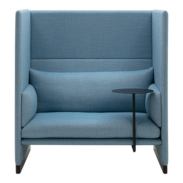 Light blue upholstered chair with clean lines, featuring a simple black side table and smooth fabric texture.