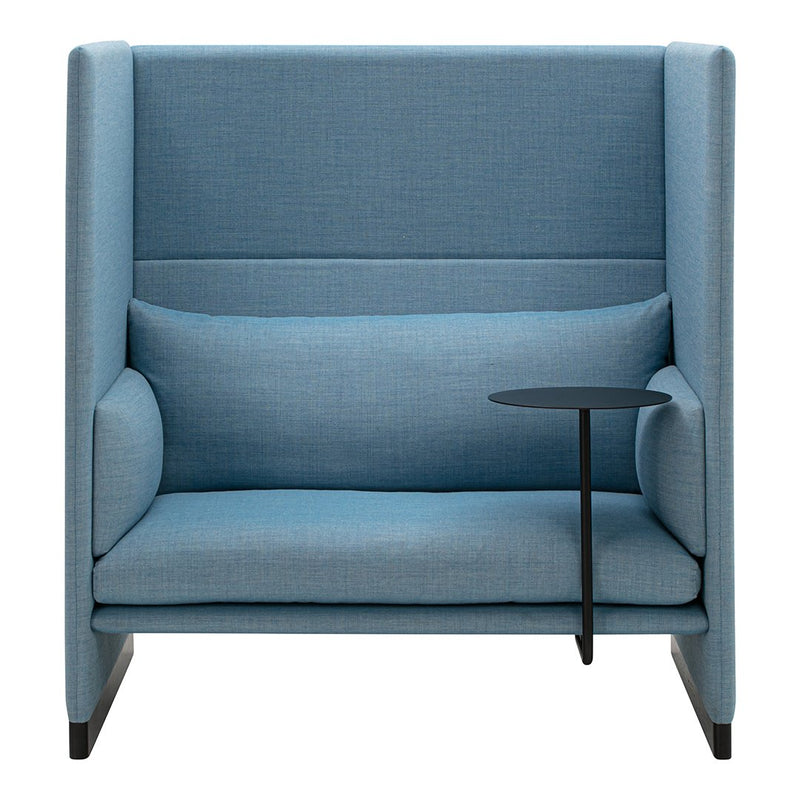 Light blue upholstered chair with clean lines, featuring a simple black side table and smooth fabric texture.