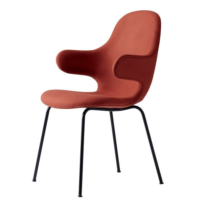 Stylish rust-colored chair with smooth curves and black metal legs, perfect for modern decor.