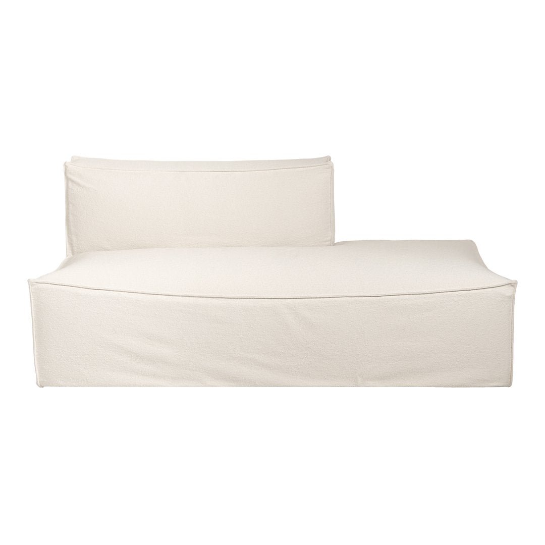 Cream-colored chaise lounge with a minimalist design and smooth, solid fabric texture. Perfect for modern interiors.