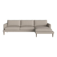 Beige sectional sofa with clean lines and textured, solid-pattern upholstery, featuring wooden legs for a modern look.