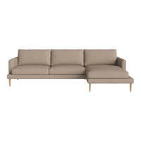 Stylish beige sectional sofa with a smooth, textured fabric and light wooden legs, perfect for modern decor.
