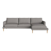 Gray sectional sofa with a sleek design and light wooden legs, featuring a smooth, solid fabric upholstery.