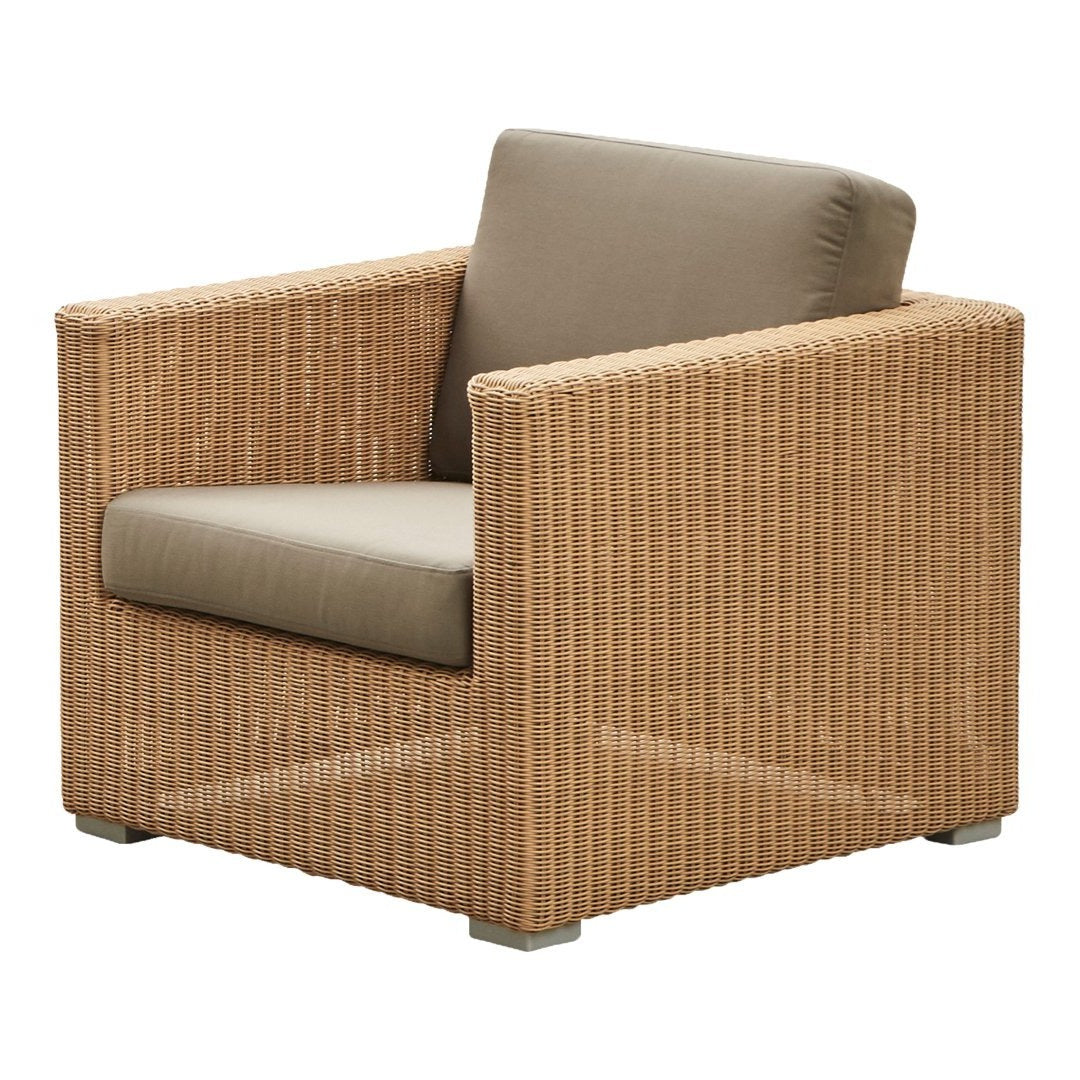 Tan wicker armchair with a beige cushion, featuring a sleek, modern design. Ideal for indoor or outdoor use.