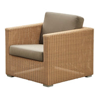 Tan wicker armchair with a beige cushion, featuring a sleek, modern design. Ideal for indoor or outdoor use.