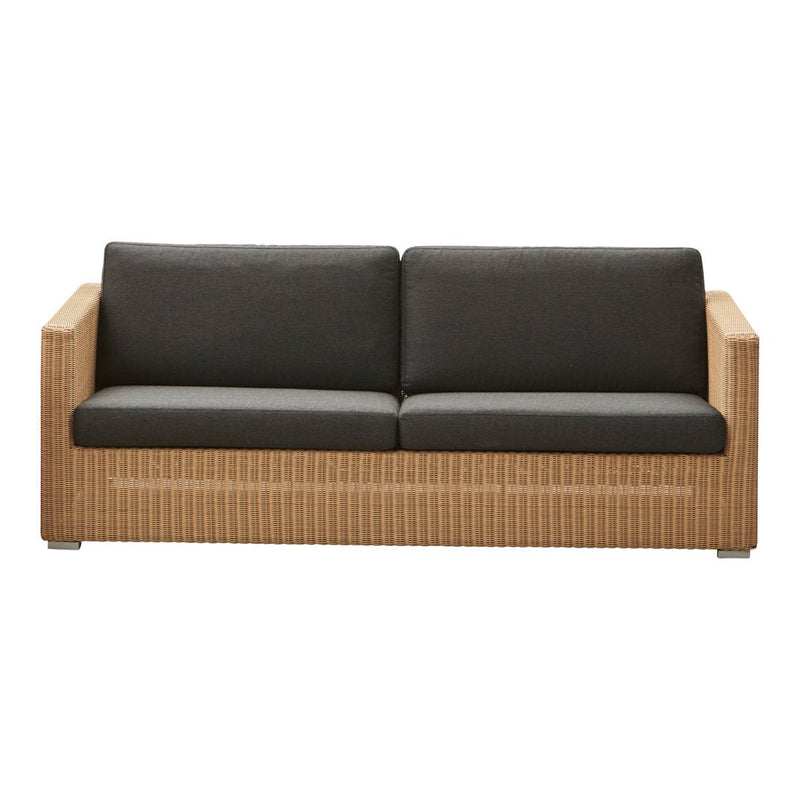 "Natural rattan sofa with dark gray cushions and woven pattern accents, ideal for modern outdoor spaces."
