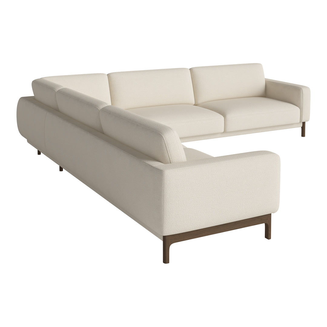 Cream-colored sectional sofa with a smooth, minimalist design and brown wooden legs. Perfect for modern interiors.