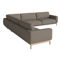 Modern sectional sofa in soft taupe fabric with clean lines and minimalistic design, featuring light wooden legs.
