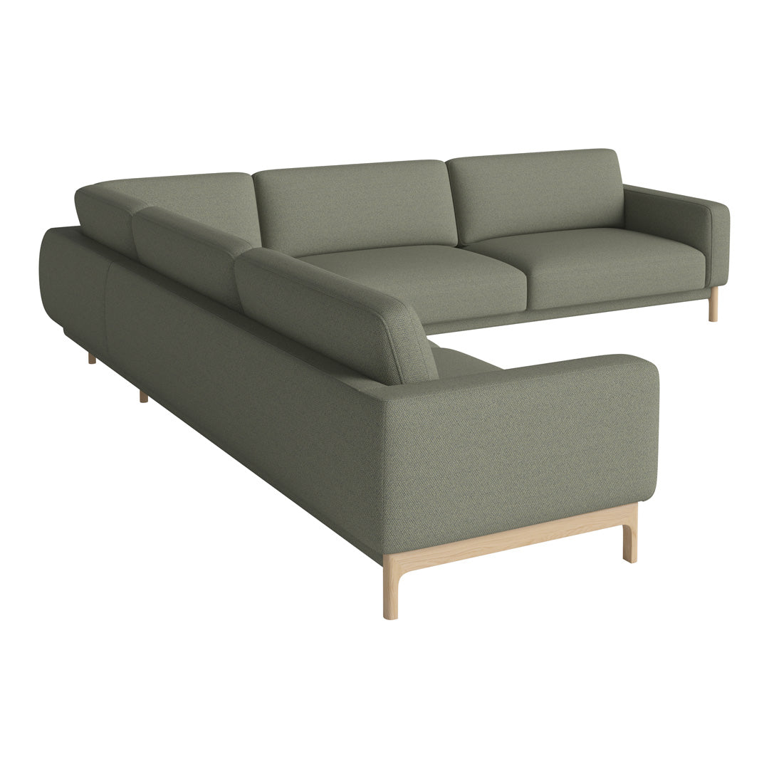 Modern sectional sofa in soft olive green fabric with clean lines and light wood legs, perfect for contemporary decor.