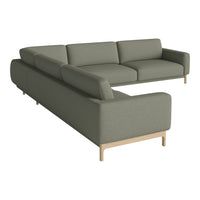 Modern sectional sofa in soft olive green fabric with clean lines and light wood legs, perfect for contemporary decor.