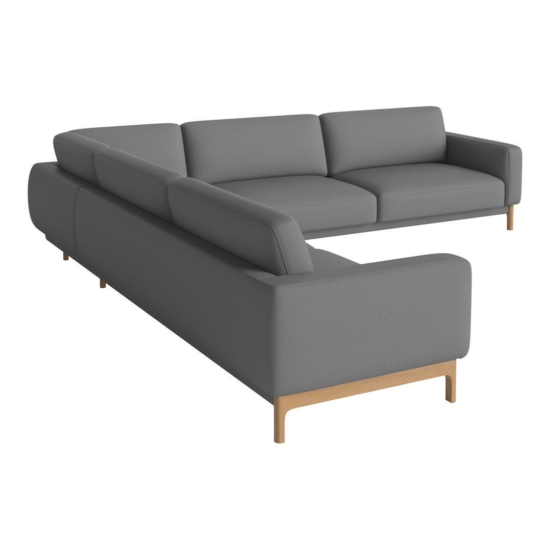 Modern L-shaped sofa in sleek gray upholstery with light wood legs, featuring a minimalist design.