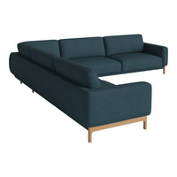 Teal sectional sofa with clean lines and wooden legs, featuring a smooth, textured fabric pattern.