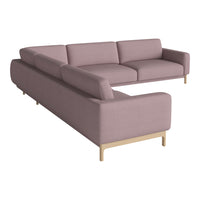 Modern sectional sofa in soft mauve fabric with clean lines and natural wood legs. Ideal for stylish living spaces.