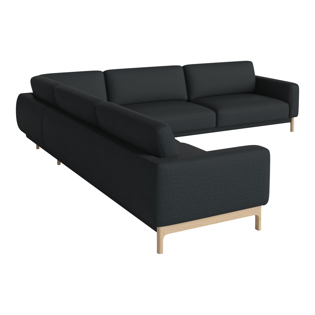Modern black sectional sofa with clean lines and soft fabric; features light wood legs for a stylish contrast.