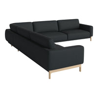 Modern black sectional sofa with clean lines and soft fabric; features light wood legs for a stylish contrast.