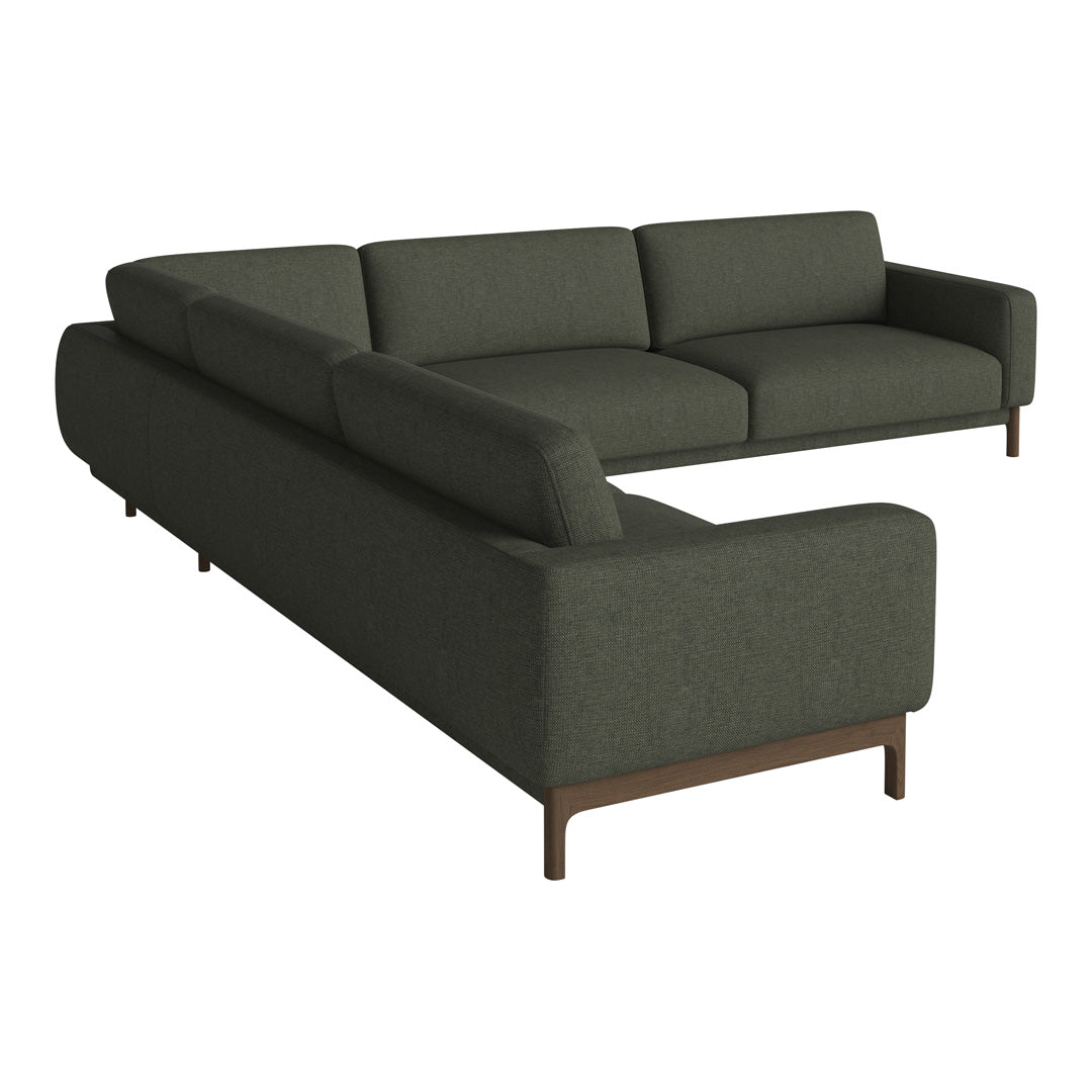 Modern L-shaped sofa in deep green fabric with a minimalist design and wooden legs. Perfect for contemporary interiors.