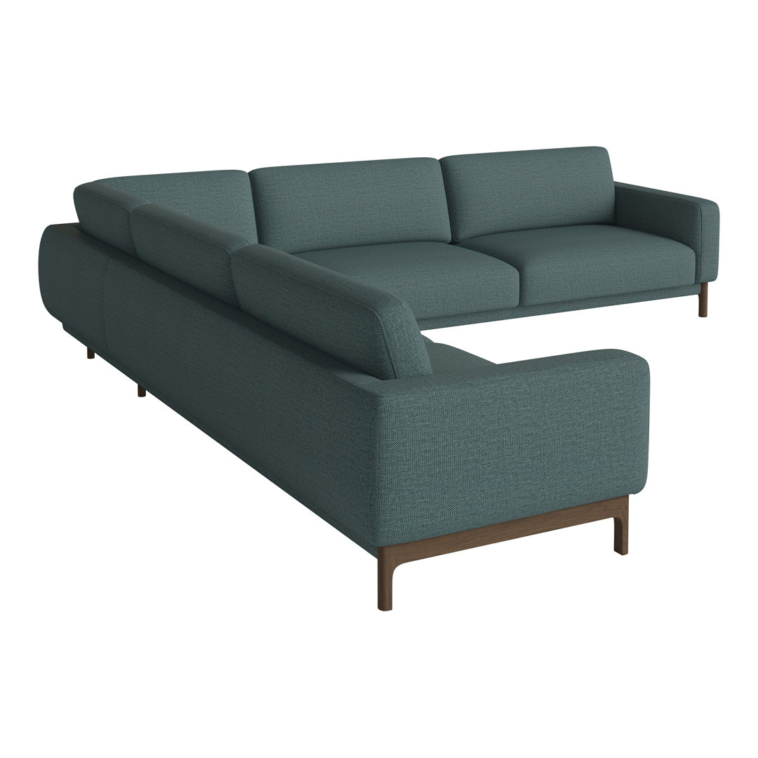 Teal sectional sofa with a smooth fabric texture and minimalist design, featuring sleek wooden legs.