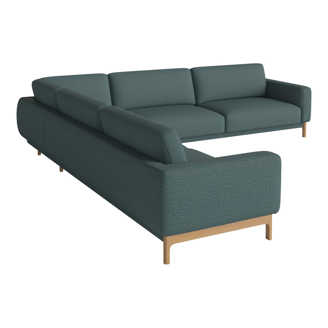Teal sectional sofa with a smooth finish and wooden legs, featuring a modern, minimalist design.