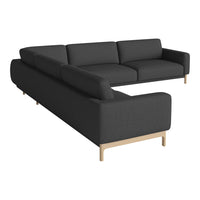Modern L-shaped sofa in dark gray fabric with clean lines and natural wood legs, perfect for contemporary decor.