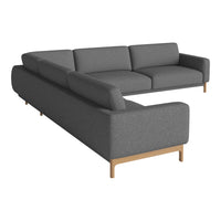 Gray sectional sofa with a sleek, modern design and smooth fabric, complemented by light wooden legs.