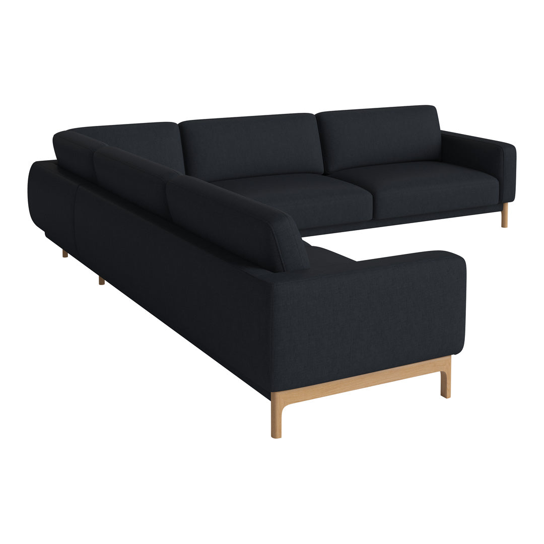 Black sectional sofa with sleek lines and a modern design, featuring a minimalist aesthetic and light wood legs.