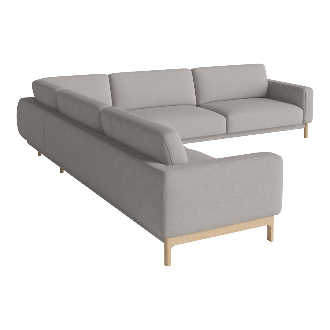 Light gray sectional sofa with clean lines and minimalist design. Soft fabric upholstery and wooden legs.