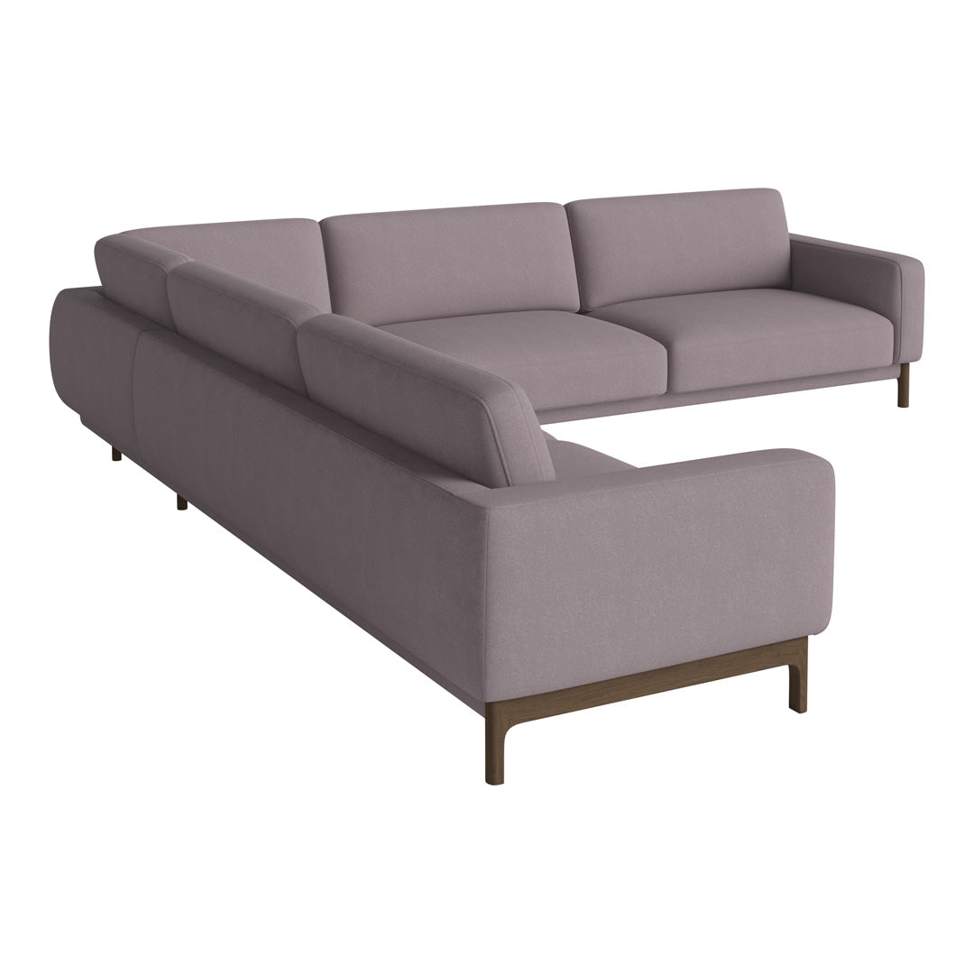 Modern L-shaped sofa in soft mauve fabric with sleek lines and minimalist design, perfect for contemporary decor.