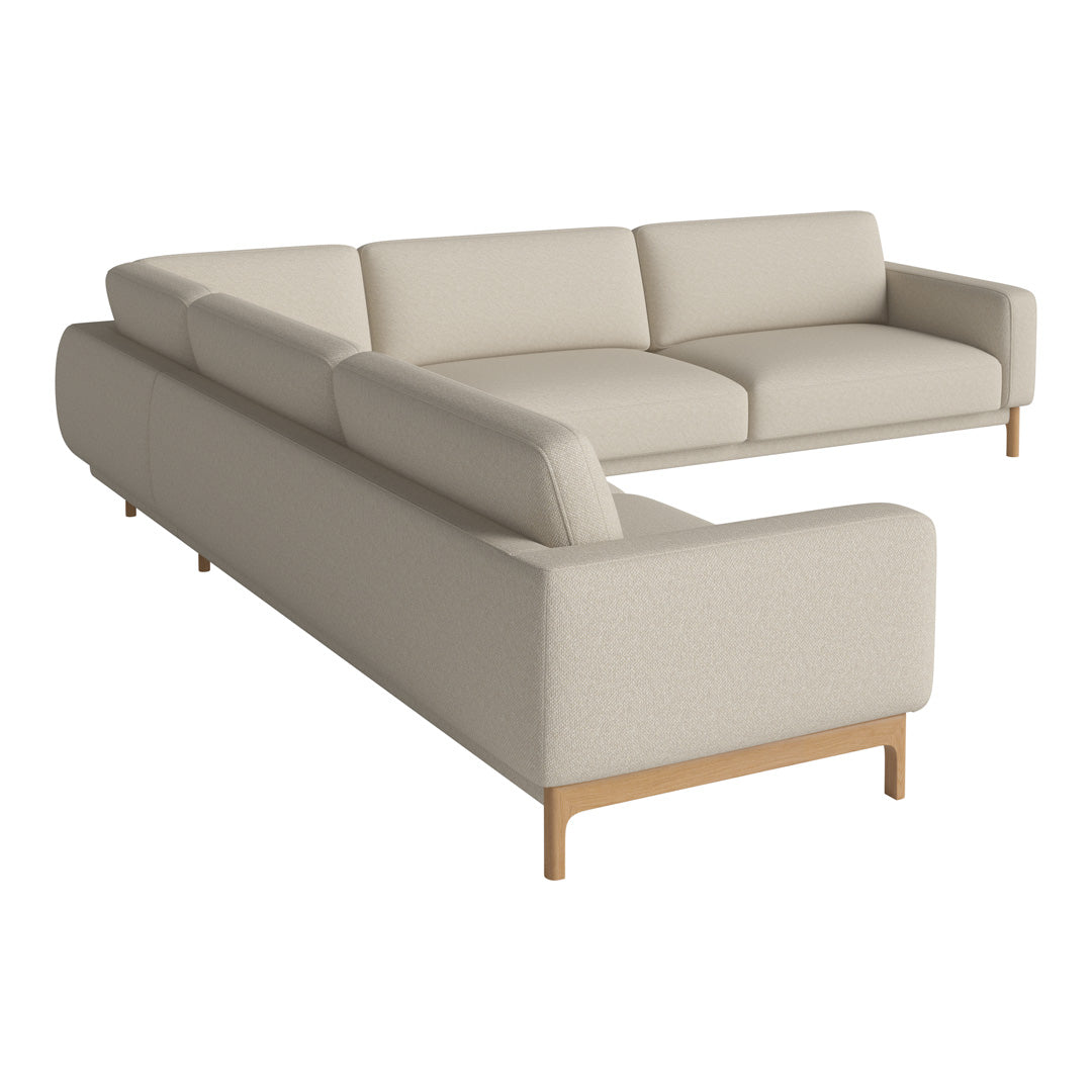 Beige sectional sofa with clean lines and a minimalist design, featuring a solid wood base and upholstery in a neutral tone.