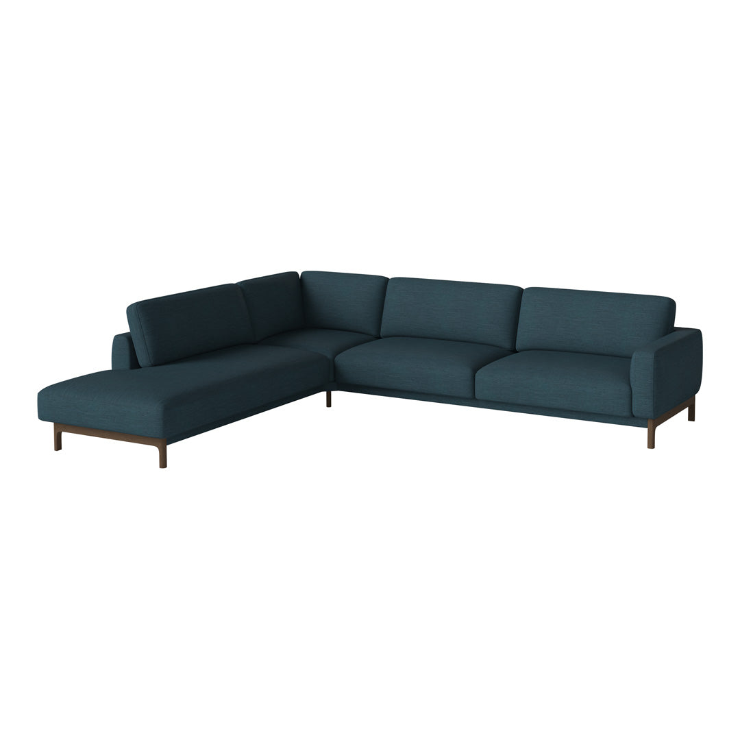 Teal sectional sofa with sleek lines and minimalist design, featuring a solid color upholstery and wooden legs.
