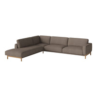 Brown sectional sofa with a sleek, modern design and soft fabric upholstery, complemented by light wooden legs.