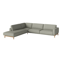 Light gray sectional sofa with a minimalist design and smooth upholstery, featuring wooden legs for added elegance.