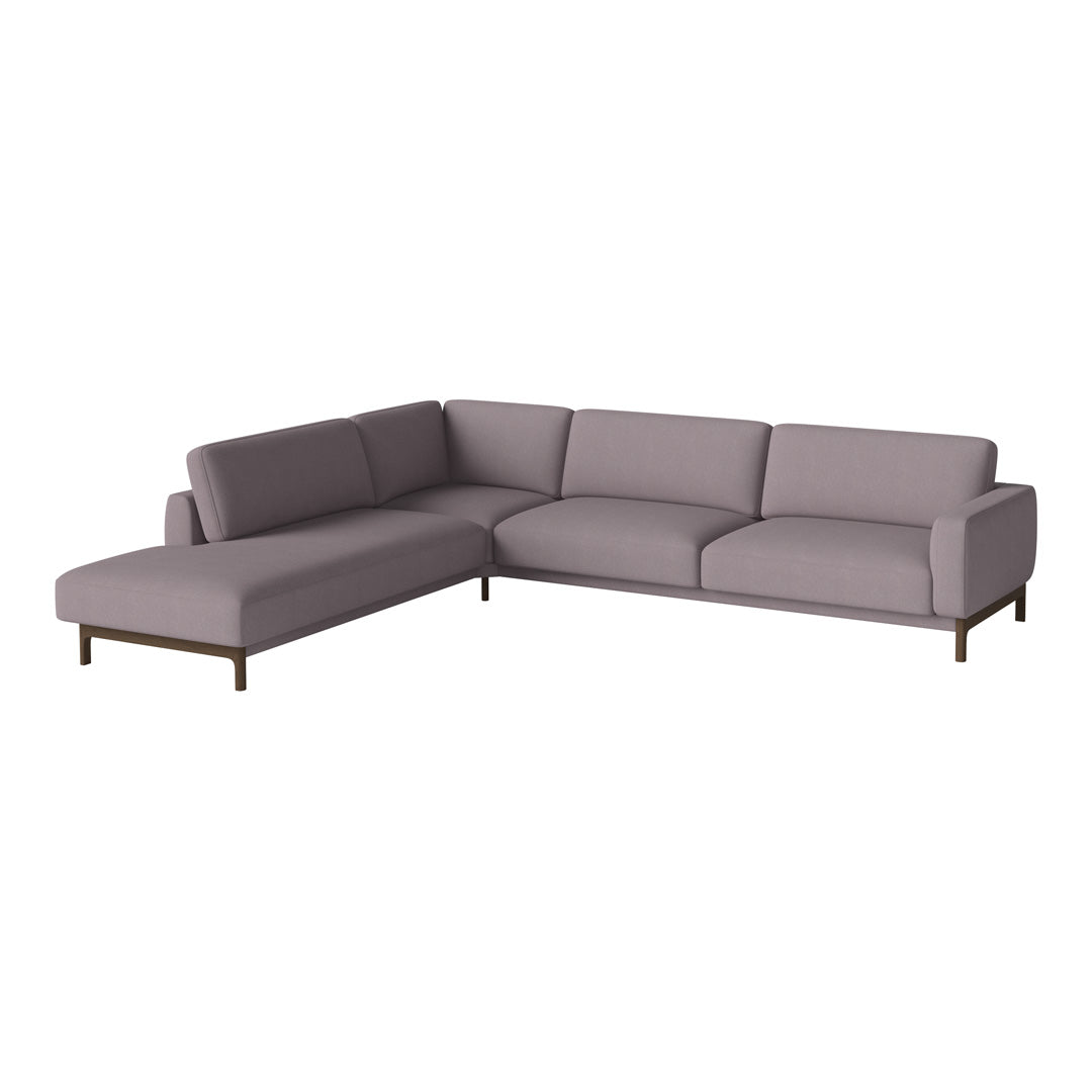 L-shaped sofa in soft lavender fabric with clean lines and subtle texture, complemented by dark wooden legs.
