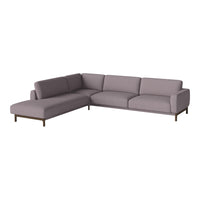 L-shaped sofa in soft lavender fabric with clean lines and subtle texture, complemented by dark wooden legs.