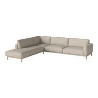 Light beige sectional sofa with smooth upholstery and natural wood legs, featuring a minimalist design.