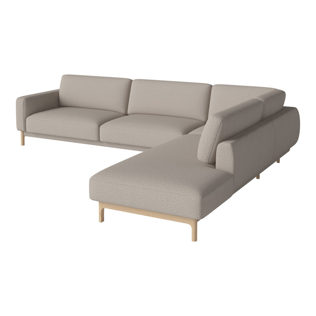 Light gray sectional sofa with clean lines and minimalist design, featuring soft, textured upholstery and wooden legs.