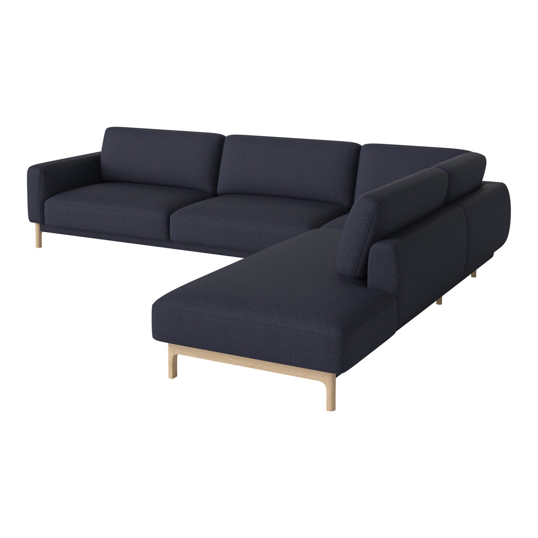 Dark navy blue sectional sofa with clean lines and minimalist design, featuring light wooden legs.