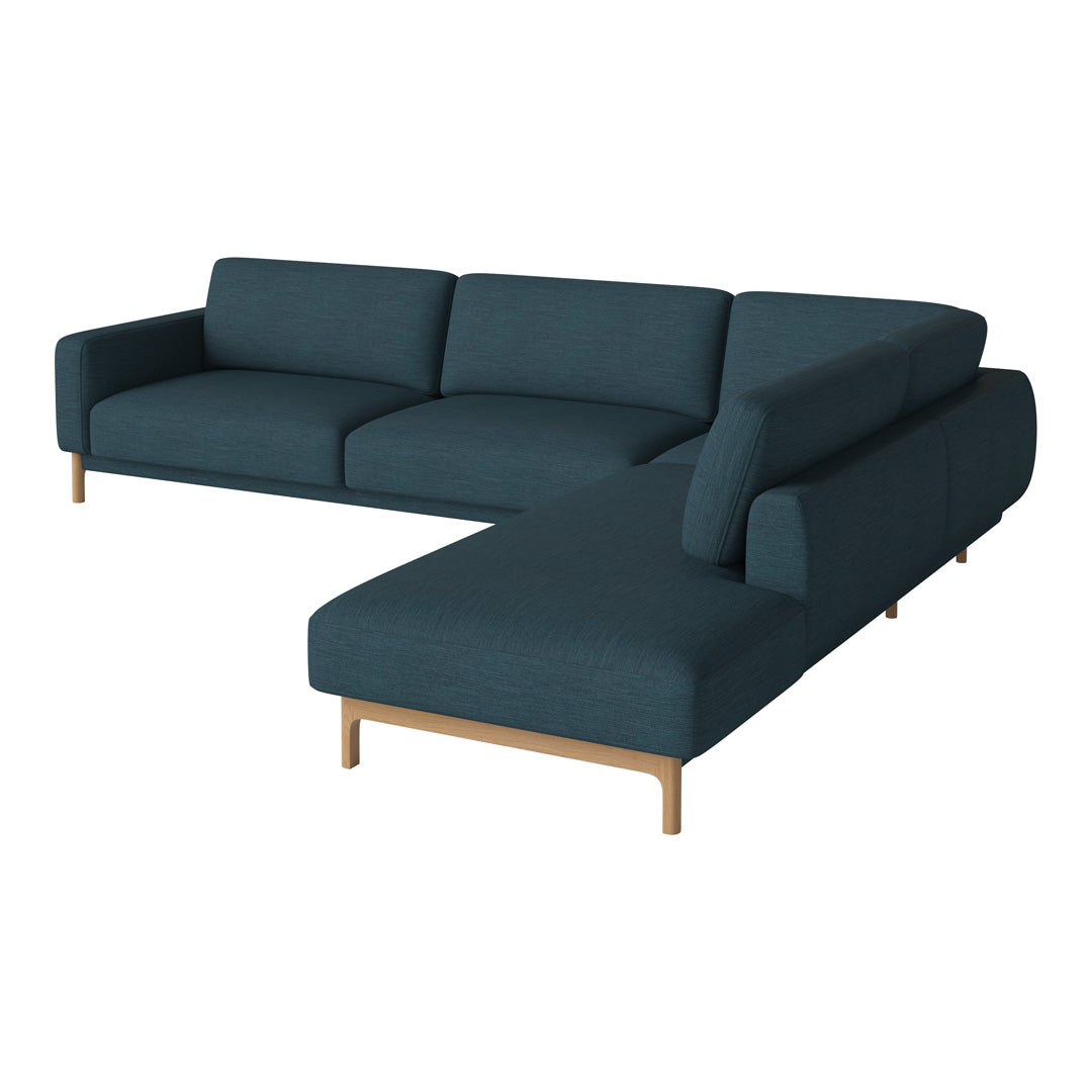 Teal sectional sofa with minimalist design and light wooden legs, featuring a solid color upholstery.